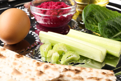 Photo of Closeup view of Passover Seder plate (keara) with traditional meal. Pesah celebration