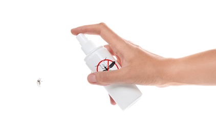 Image of Woman spraying insect repellent on mosquito against white background, closeup