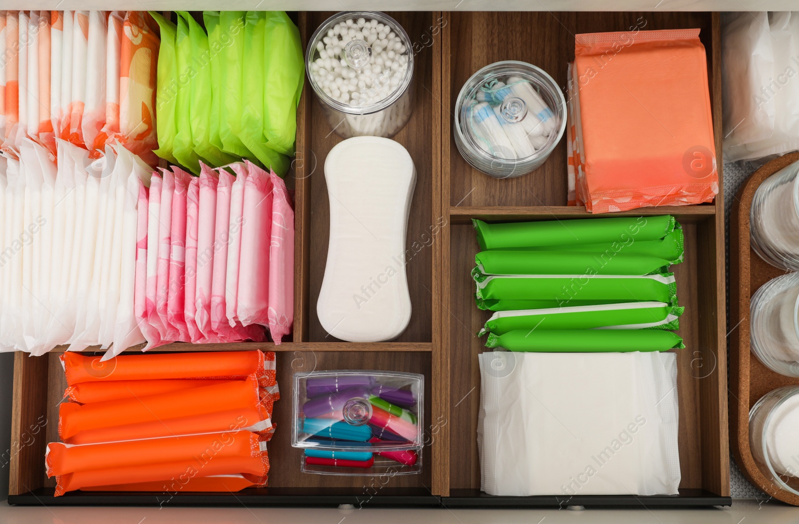 Photo of Storage of different feminine hygiene products in wooden organizers, top view