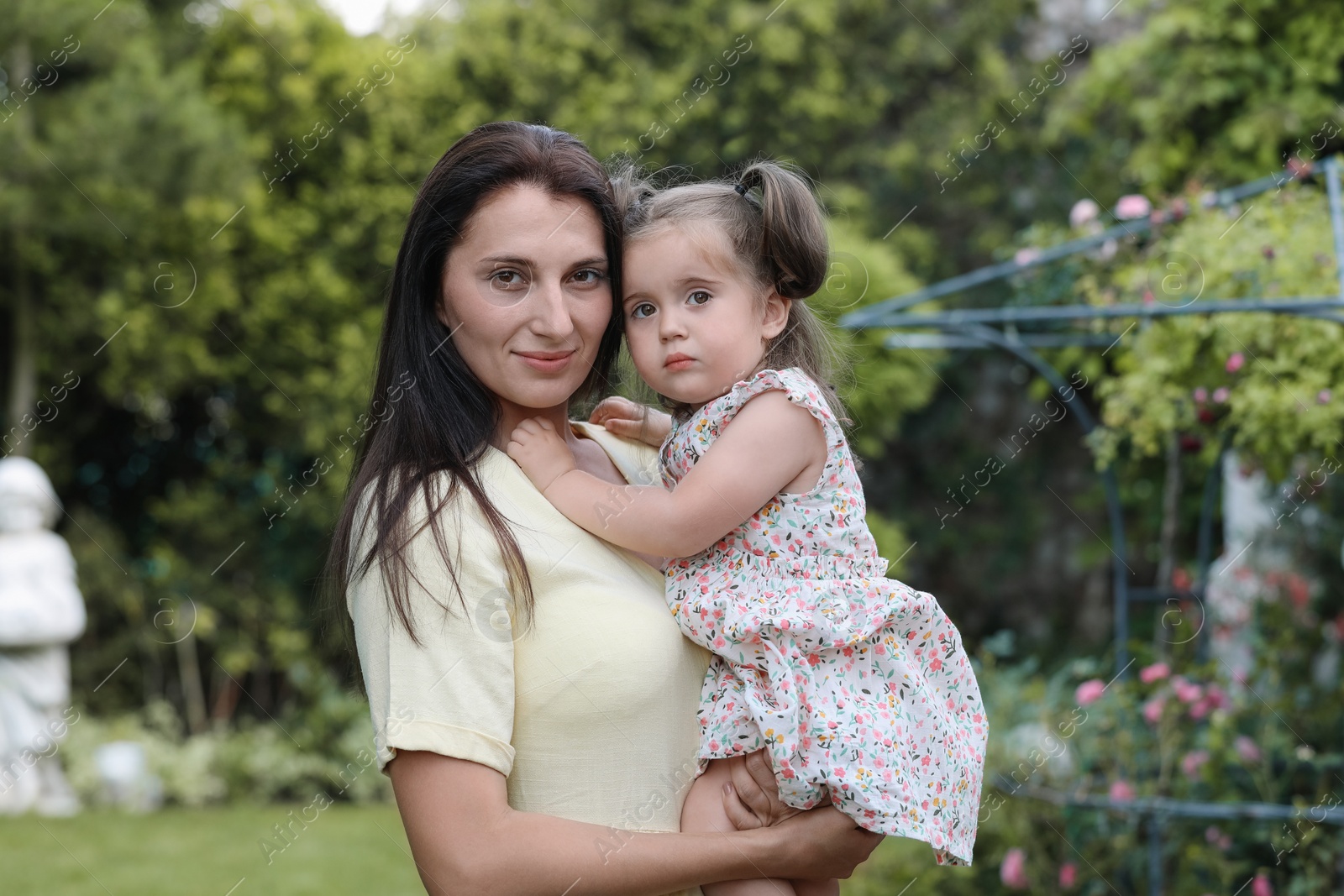 Photo of Mother with her cute daughter spending time together in park