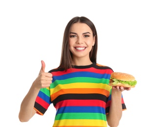 Young woman with tasty burger on white background