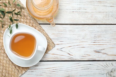 Aromatic eucalyptus tea on white wooden table, flat lay. Space for text