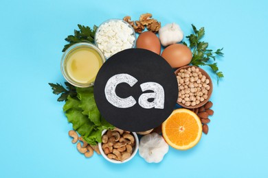 Photo of Food high in calcium. Flat lay composition with different products on light blue background