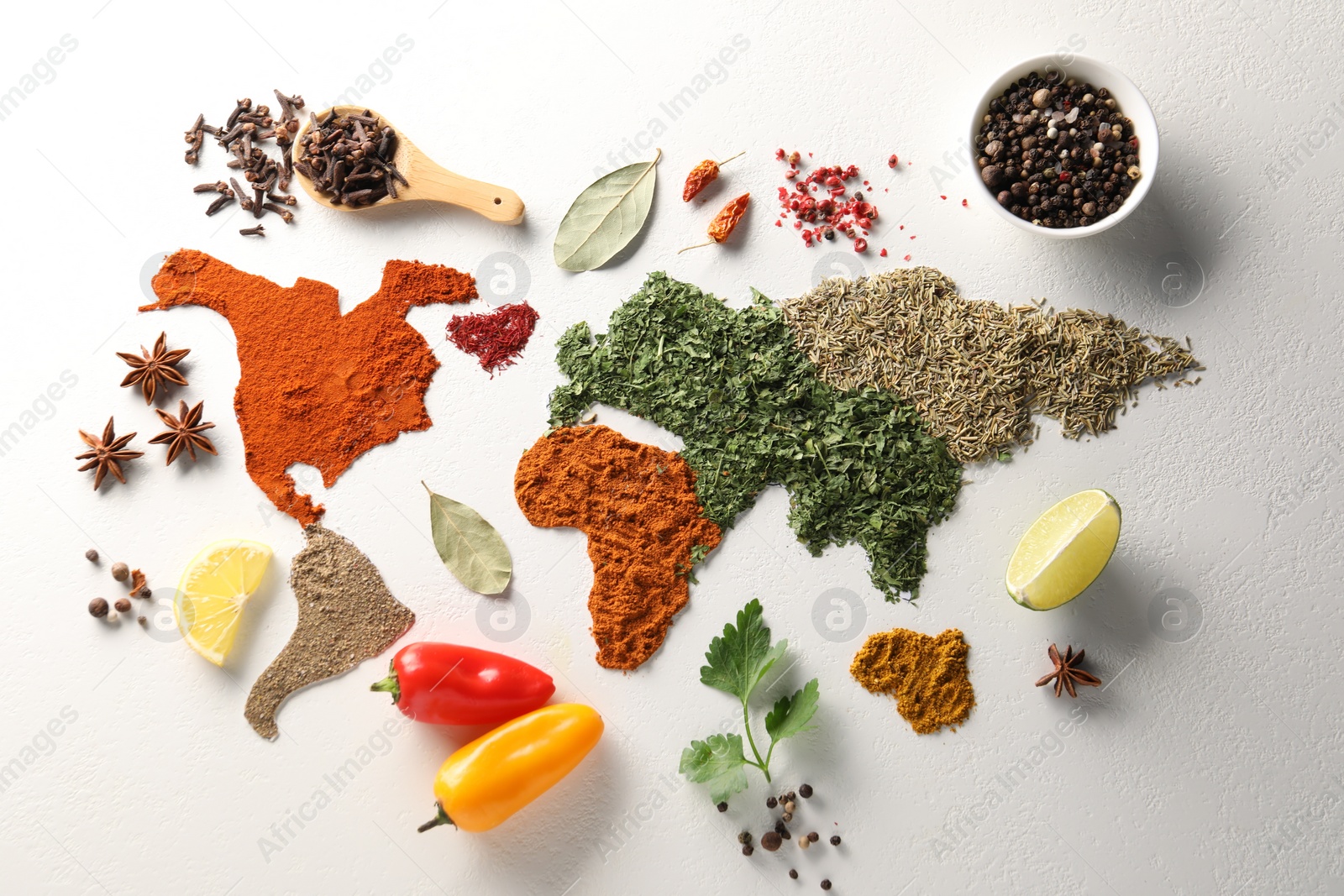 Photo of World map of different spices and products on white textured table, flat lay