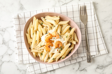 Photo of Delicious pasta with shrimps on white marble table, top view