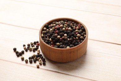 Aromatic spices. Different peppers in bowl on wooden table