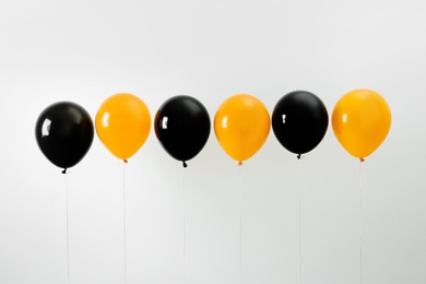 Photo of Colorful balloons on light background. Halloween party