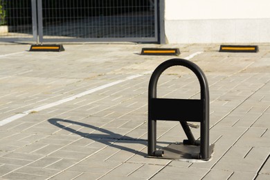 Photo of Parking barrier with No Stopping road sign on pavement outdoors, space for text