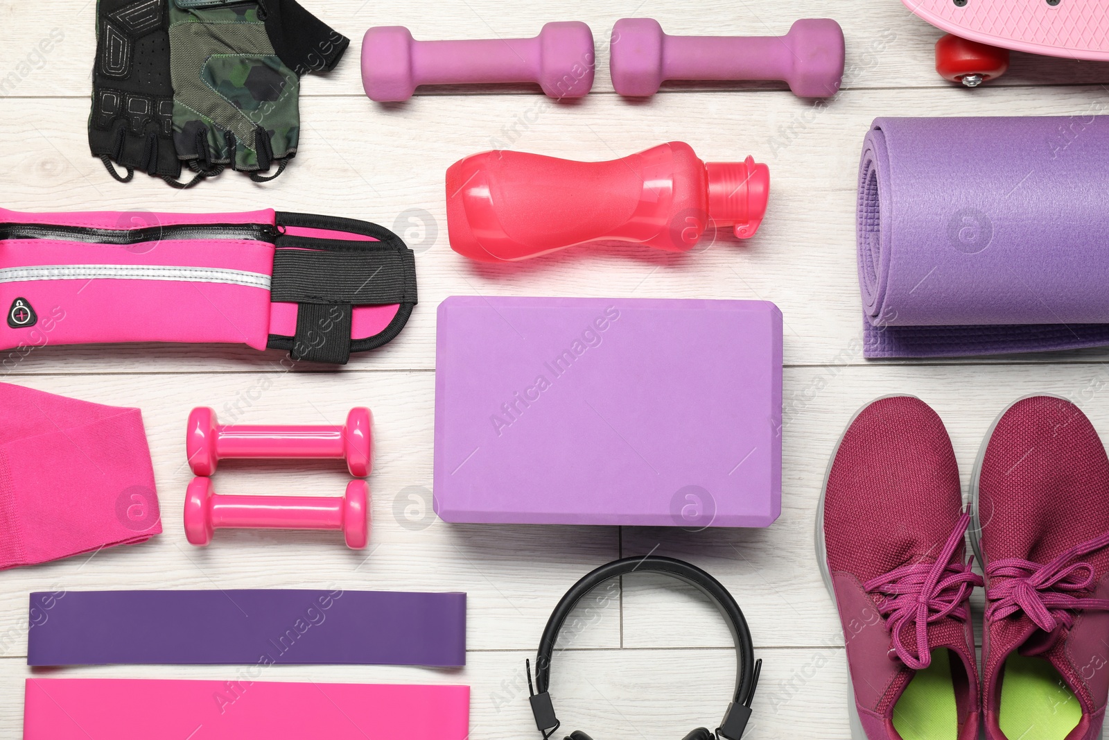 Photo of Different sports equipment on white wooden table, flat lay