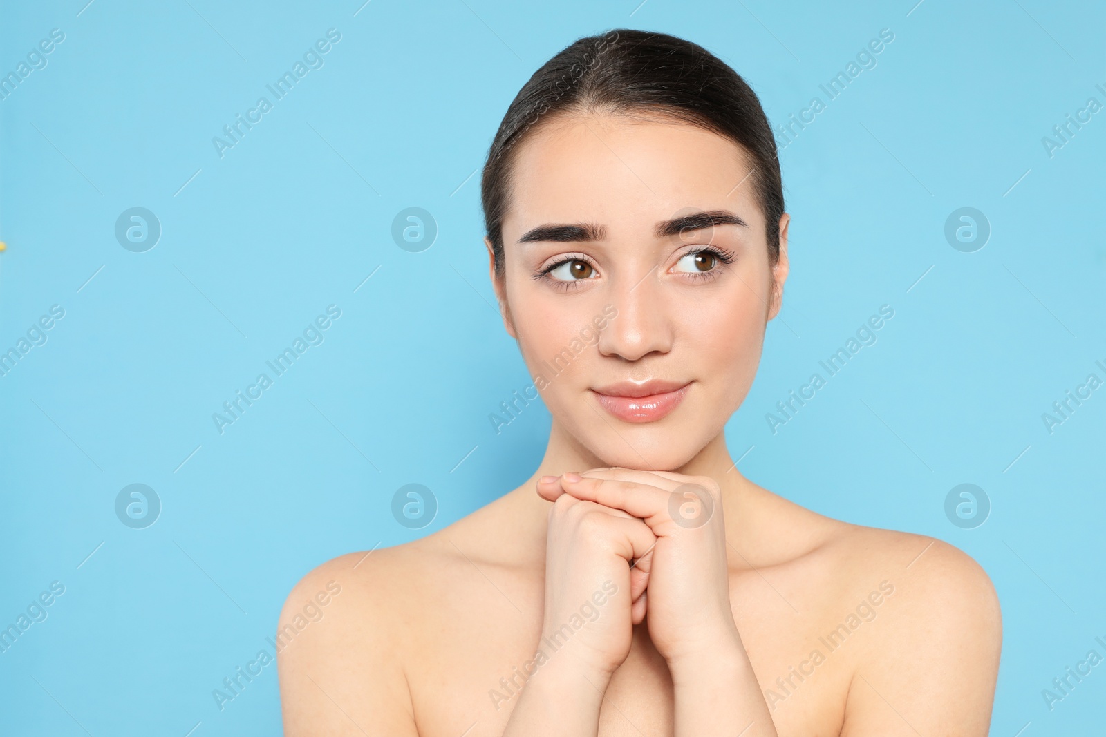 Photo of Portrait of young woman with beautiful face against color background