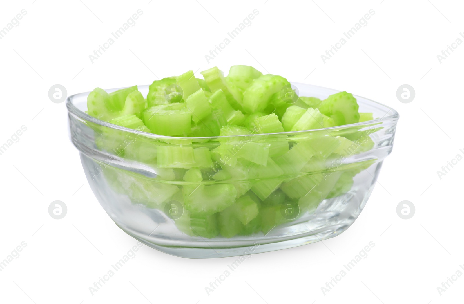 Photo of Glass bowl of fresh cut celery isolated on white