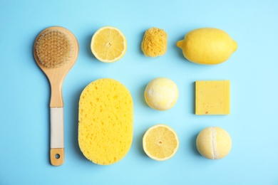 Flat lay composition with bath bombs, toiletries and lemons on color background