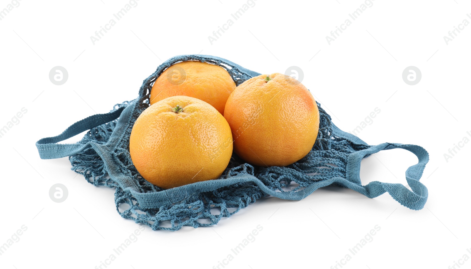Photo of String bag with oranges isolated on white