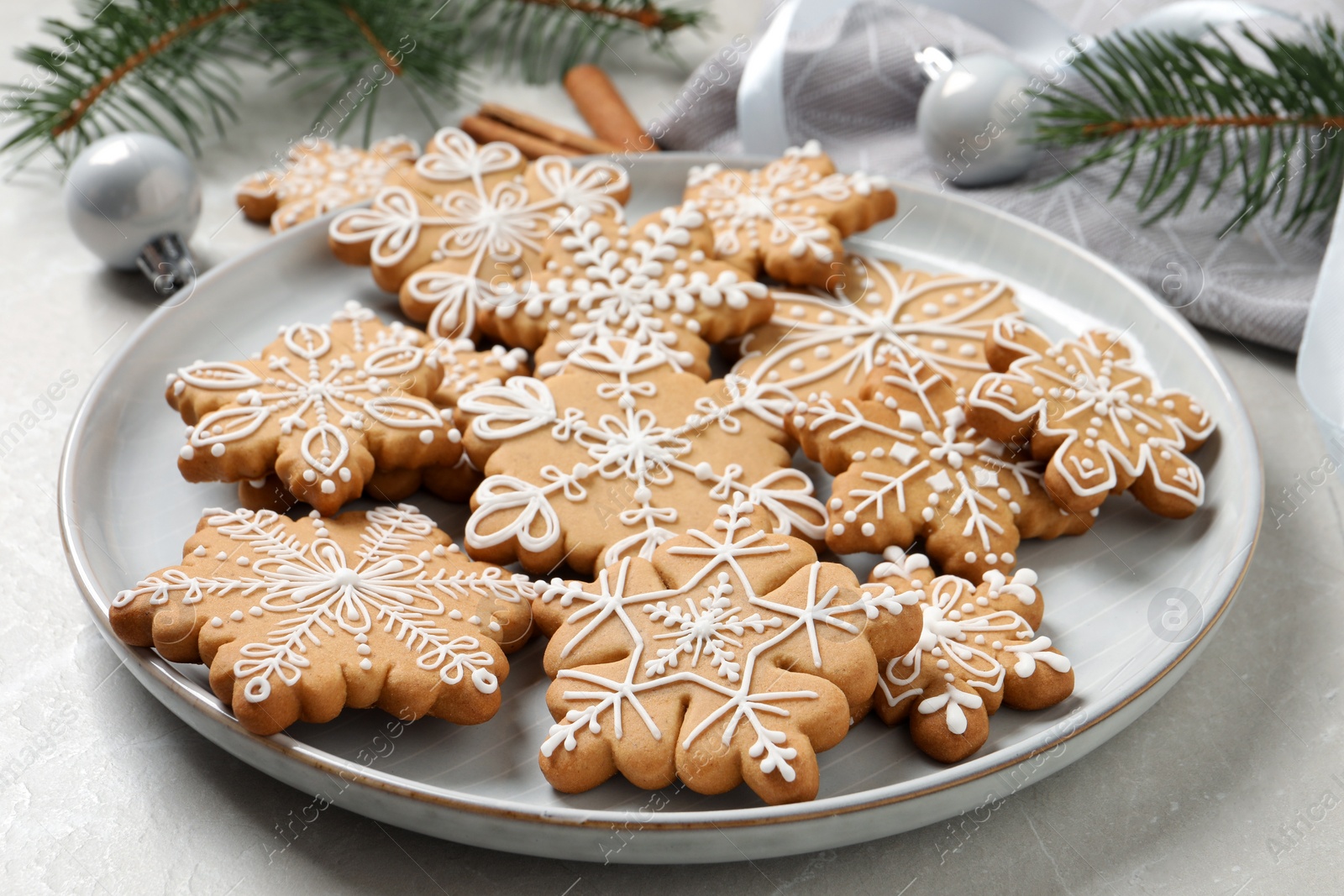 Photo of Tasty Christmas cookies on light grey table, closeup