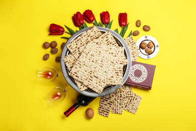 Photo of Flat lay composition with matzos on yellow background. Passover (Pesach) celebration