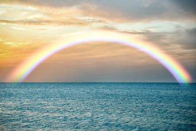 Image of Beautiful view of colorful rainbow in sky over sea