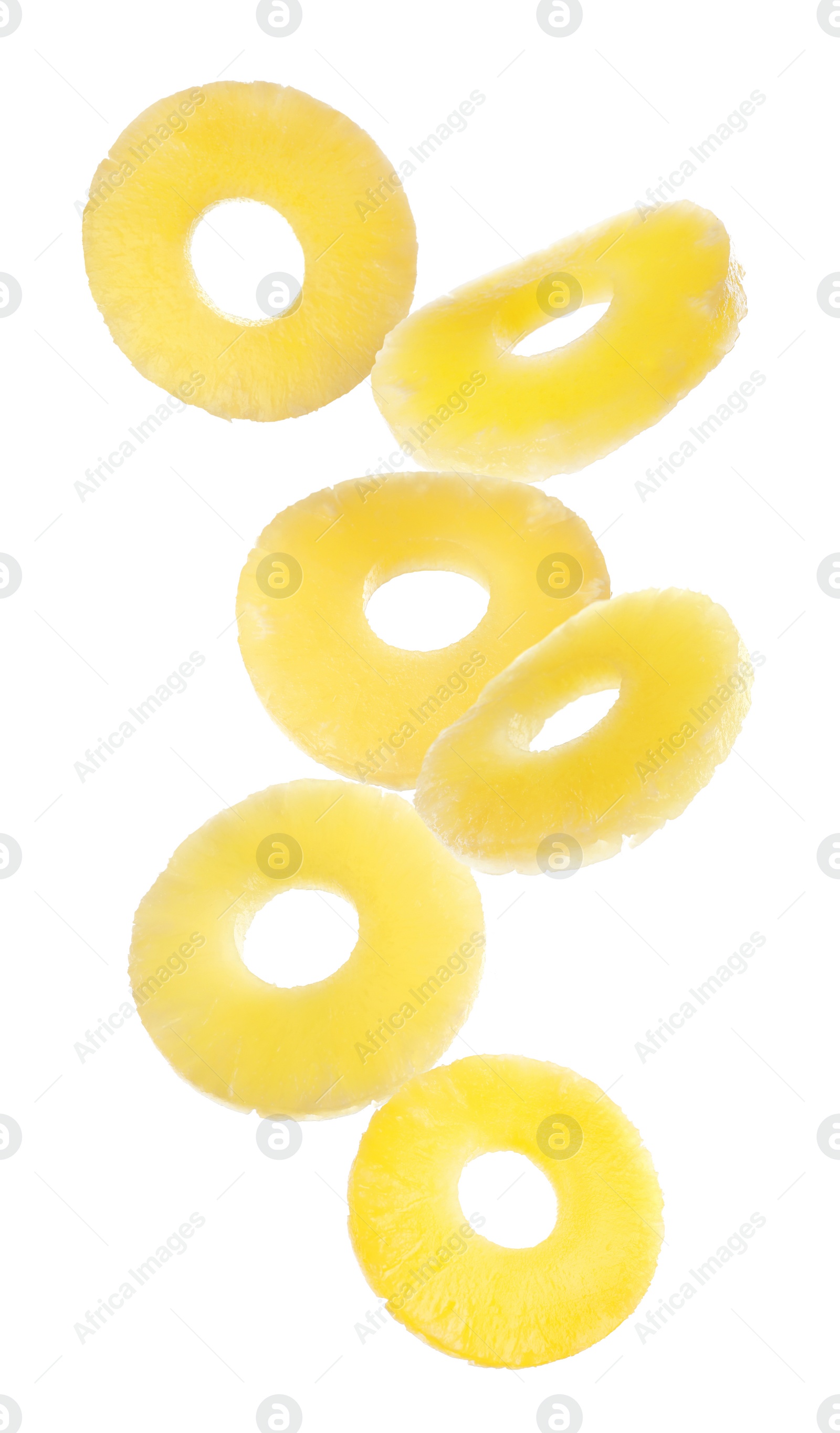 Image of Canned pineapple rings falling on white background