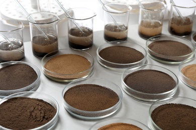 Glassware with soil samples and extracts on light table. Laboratory research