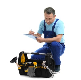 Photo of Mature plumber with clipboard and tool bag on white background