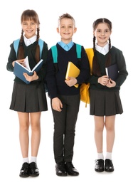 Photo of Full length portrait of cute children in school uniform with backpacks and books on white background