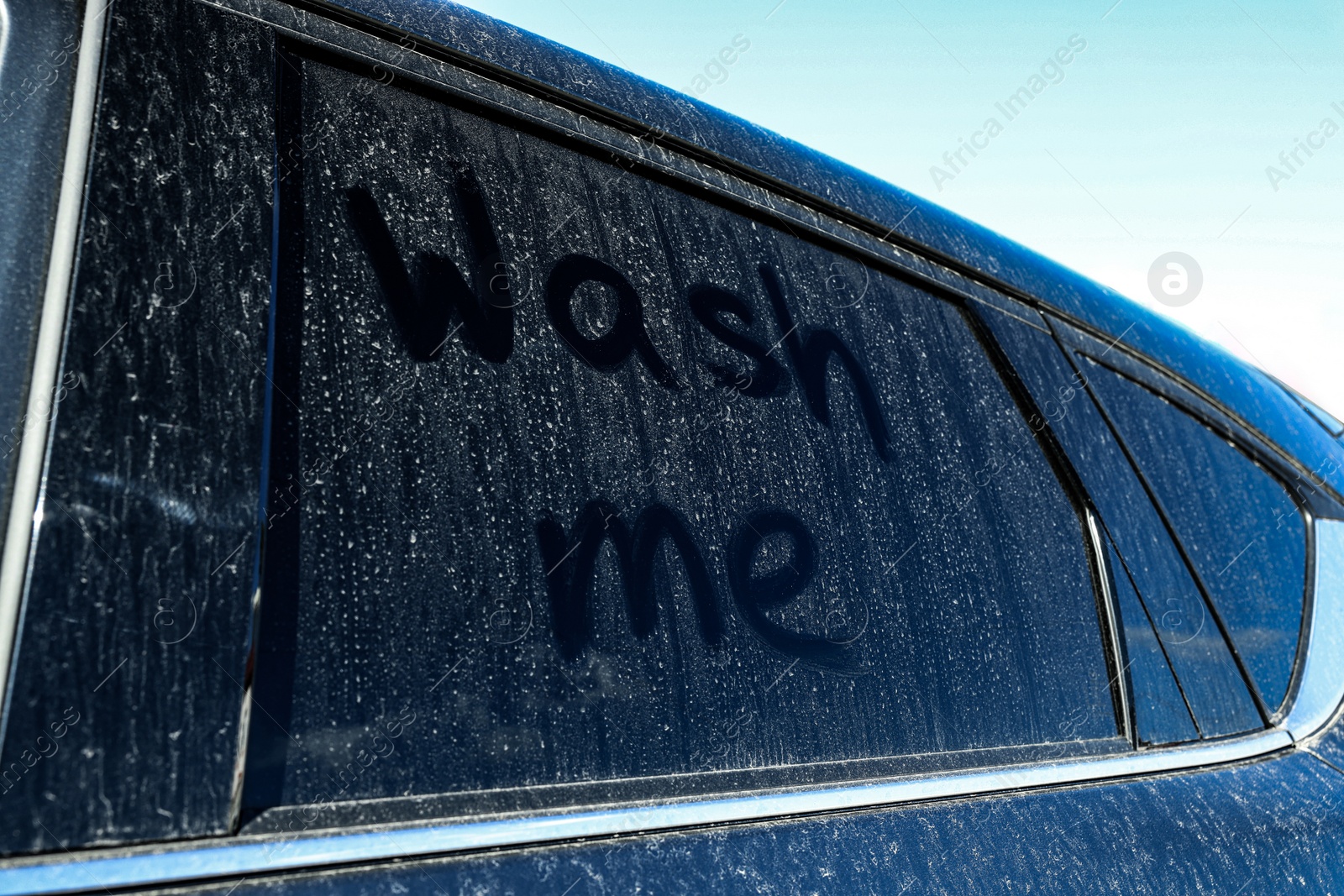 Photo of Inscription Wash me on dirty car window, closeup