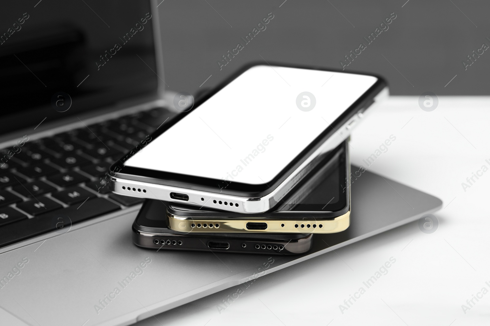 Photo of Stack of electronic devices on white table