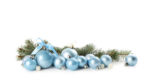 Photo of Beautiful Christmas balls and fir branches on white background