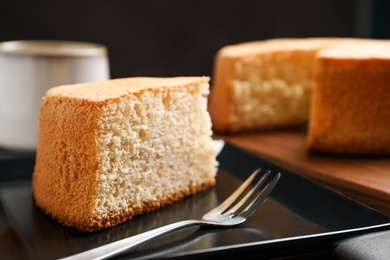 Piece of delicious fresh homemade cake served on grey table