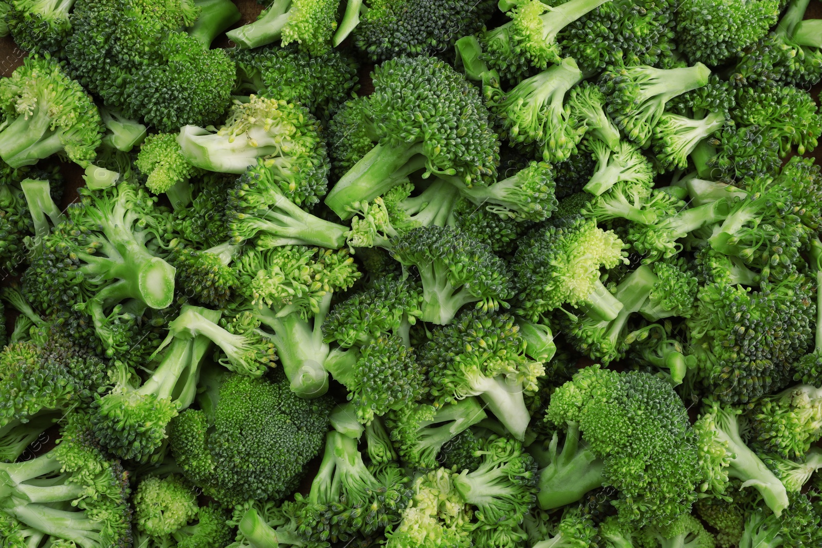 Photo of Fresh raw broccoli as background, top view