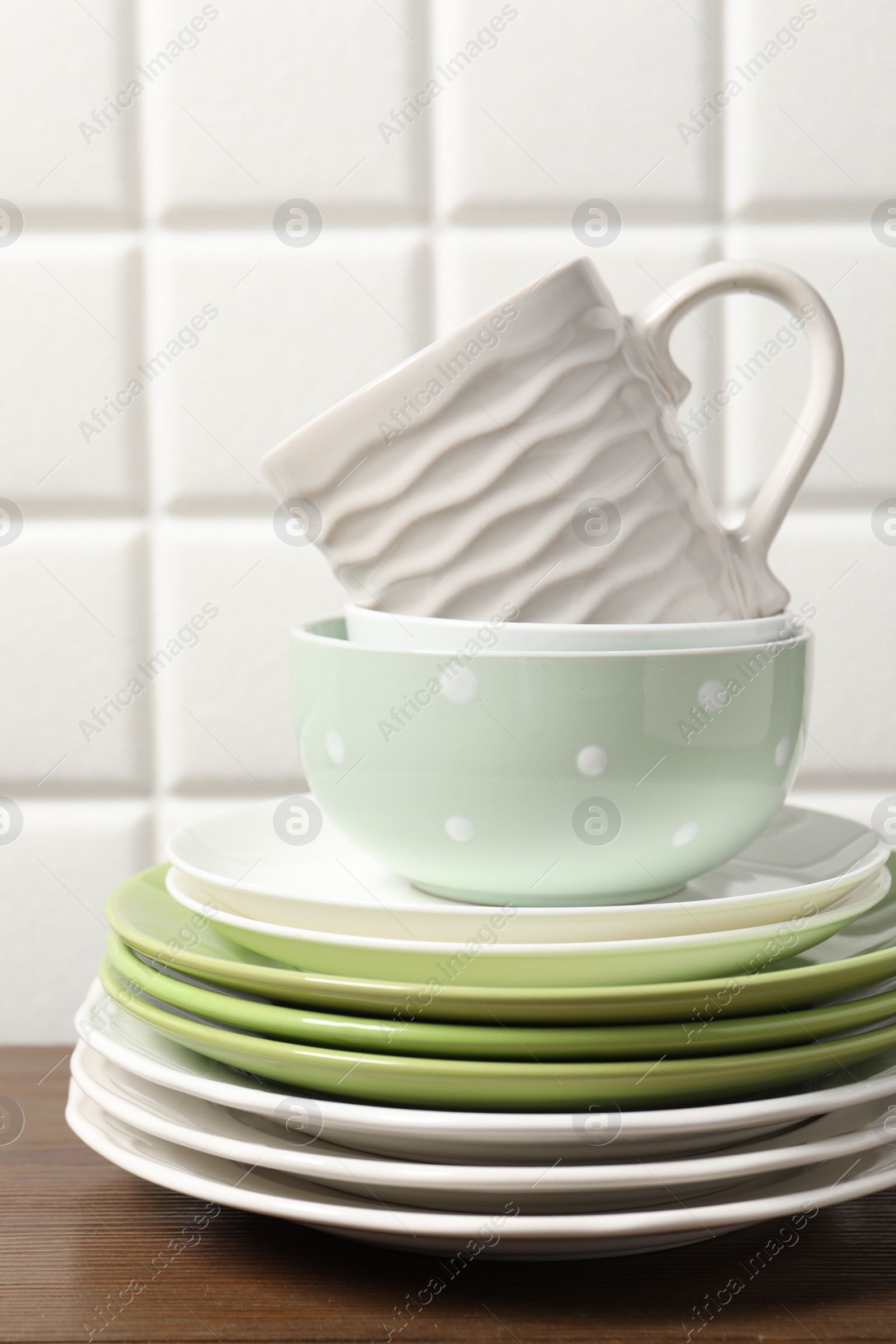 Photo of Beautiful ceramic dishware and cup on wooden table