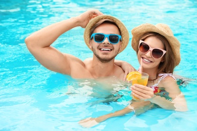 Photo of Young couple in pool on sunny day