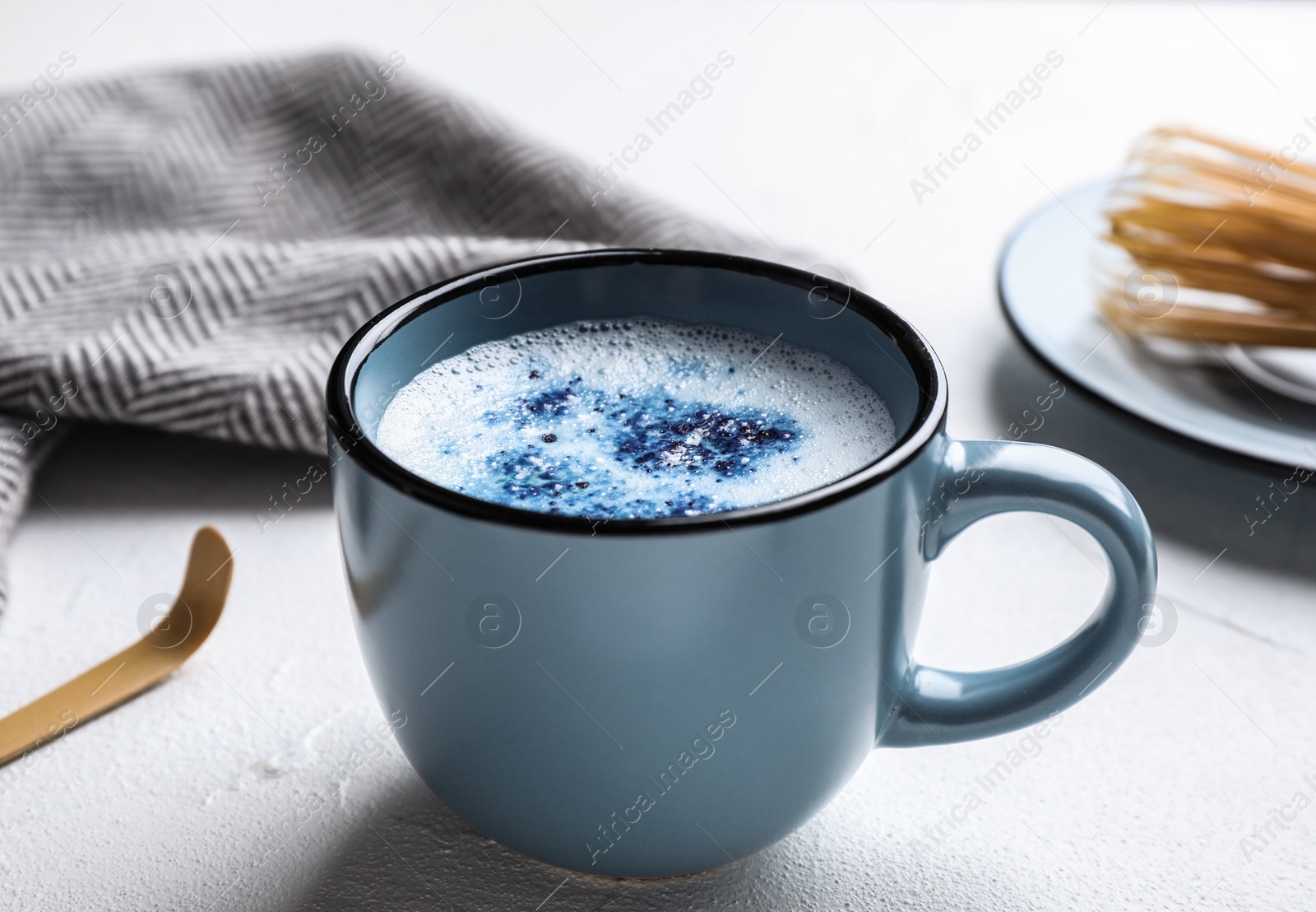 Image of Blue matcha latte in cup on light table
