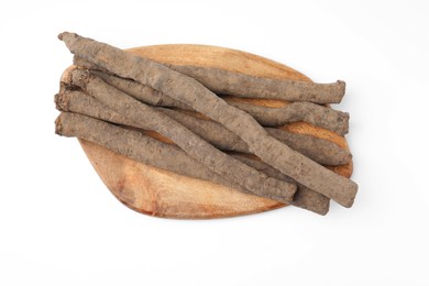 Photo of Wooden board with raw salsify roots on white background, top view