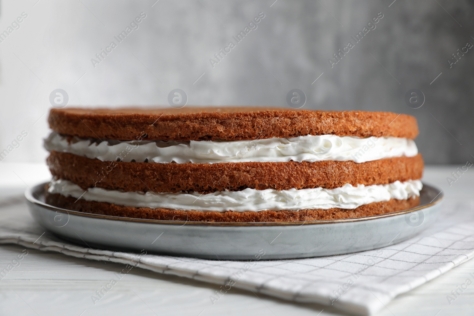 Photo of Delicious homemade layer cake on white wooden table, closeup