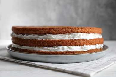 Delicious homemade layer cake on white wooden table, closeup