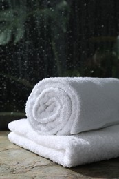 Photo of White terry towels on table in bathroom