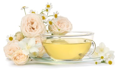 Aromatic herbal tea in glass cup and flowers isolated on white