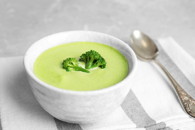 Photo of Delicious broccoli cream soup served on table