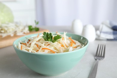 Photo of Tasty salad with cabbage and carrot on light grey marble table