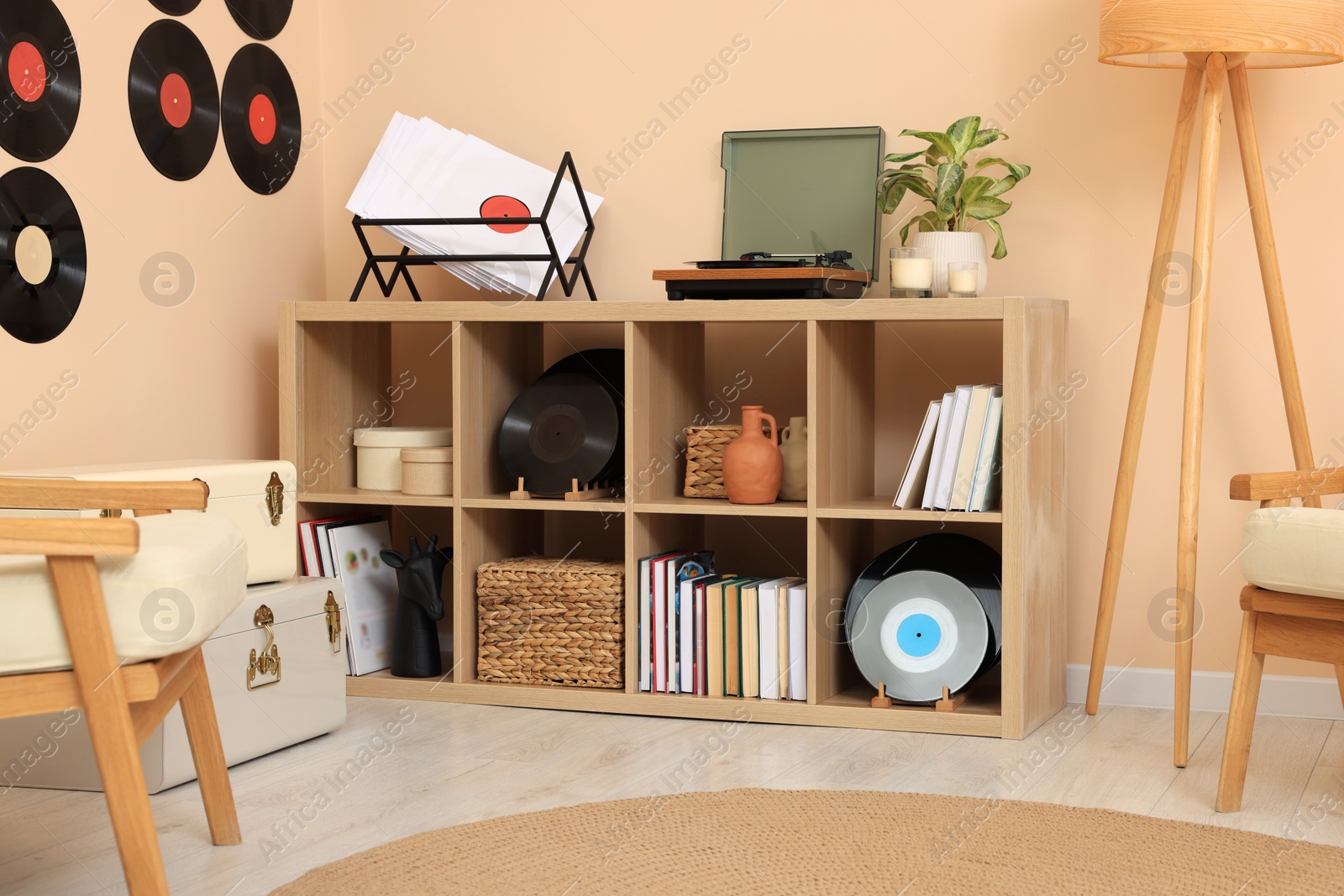 Photo of Vinyl record player on wooden shelving unit indoors