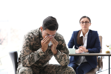 Photo of Psychotherapist working with male military officer in office