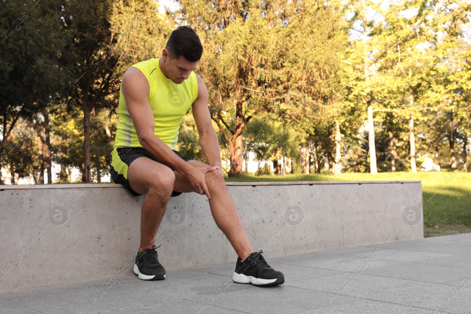 Photo of Man in sportswear having knee problems in park