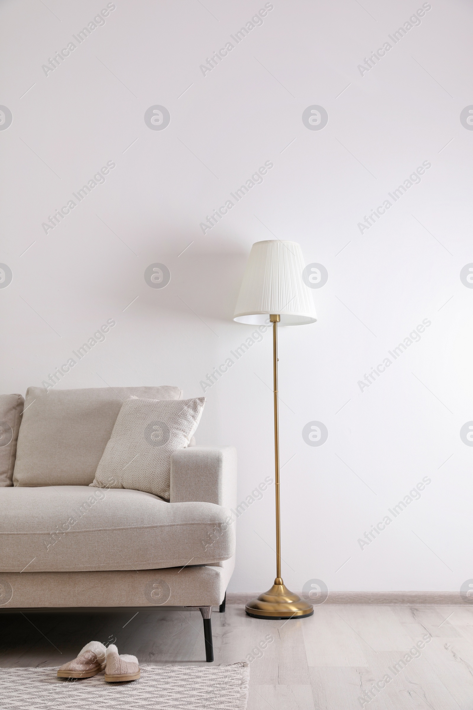 Photo of Interior of living room with comfortable sofa and floor lamp