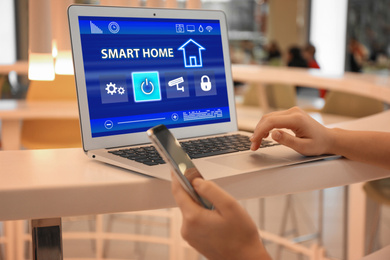 Woman using home security app indoors, closeup