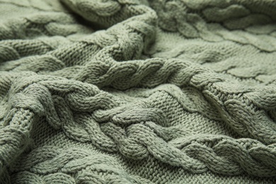 Photo of Soft knitted plaid as background, closeup view