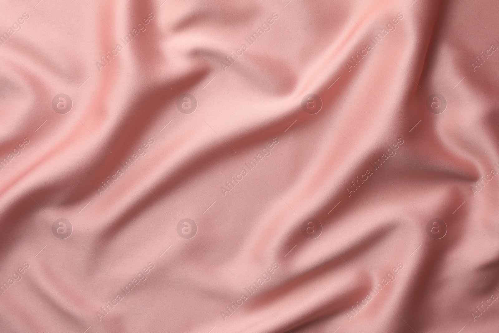 Photo of Crumpled pink silk fabric as background, top view