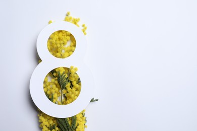 Photo of 8 March greeting card design with yellow mimosa flowers on white background, top view. Happy International Women's Day