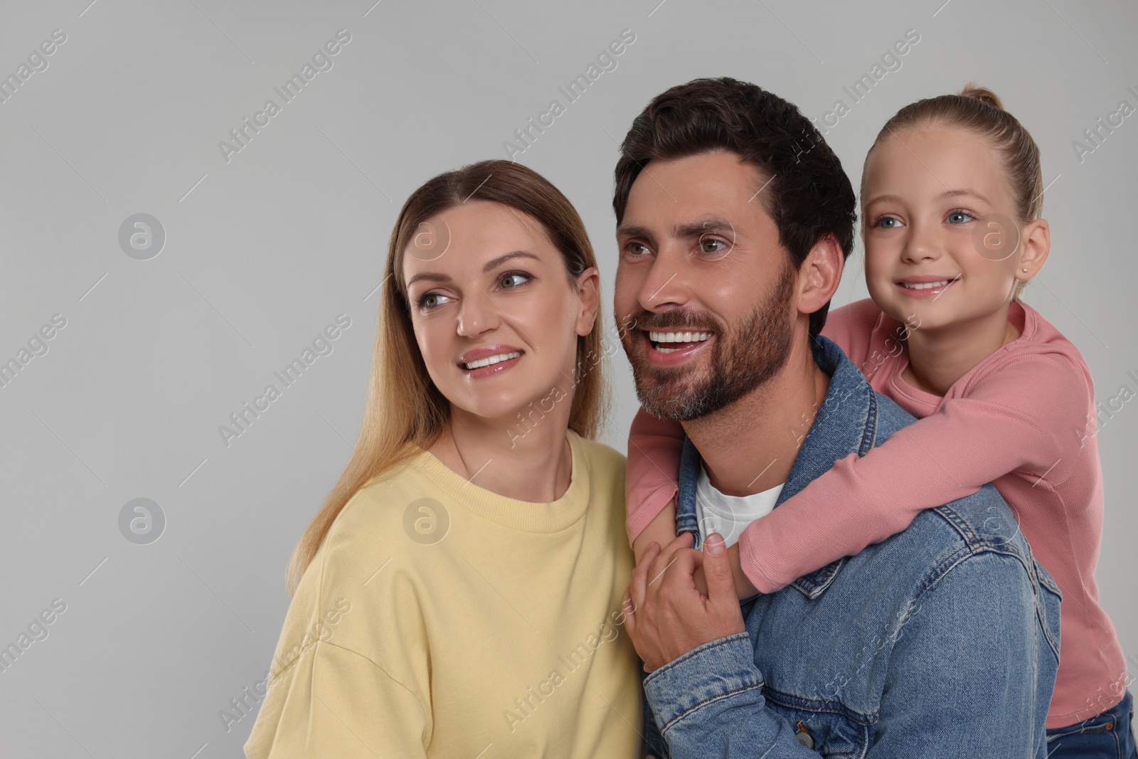 Photo of Happy family on light grey background, space for text