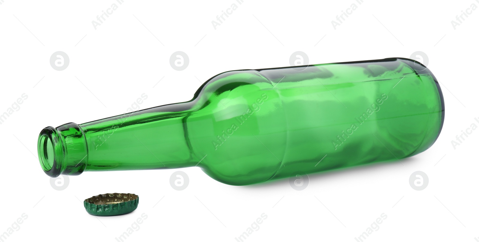 Photo of One empty green beer bottle and cap isolated on white