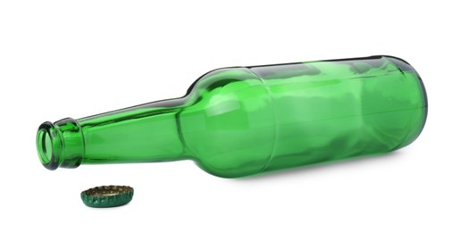 Photo of One empty green beer bottle and cap isolated on white